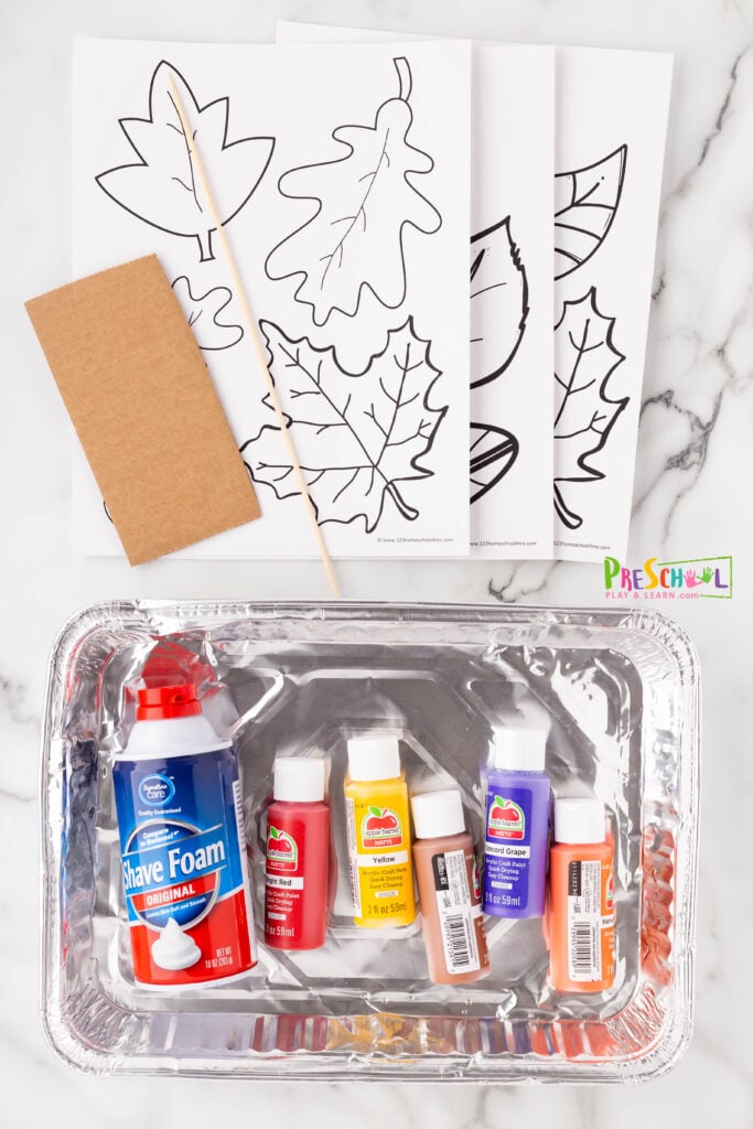 All you need to make this leaf-shaped shaving cream painting are a few simple materials:

disposable aluminum foil pan (optional, but helpful)
white shaving cream
paint in fall colors
skewer or straw
leaf cut-outs (see our free leaf template at the bottom of this post)