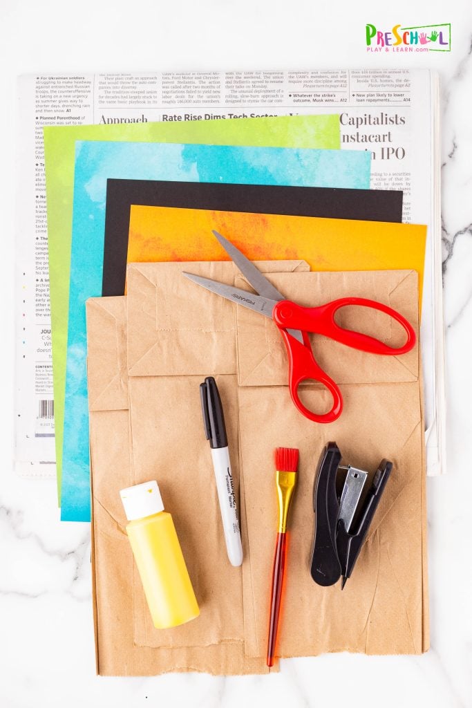 All you need are a couple simple materials to make this scarecrow craft for preschoolers:

paper bag
newspaper
stapler
scrapbook paper
cardstock
scissors
yellow paint
black or marker