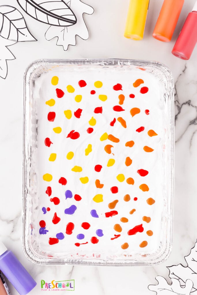 squirt in fall colored paint on top of the shaving cream